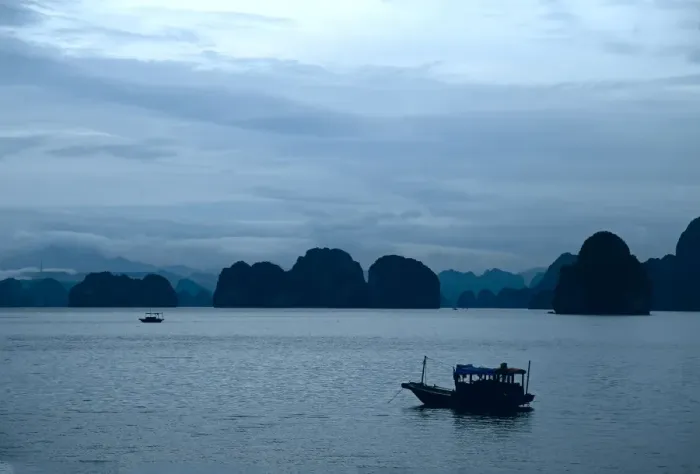 Framed Print : Small fishing boat at anchor under a moody sky, Halong Bay Framed Print : Small fishing boat at anchor under a moody sky, Halong Bay