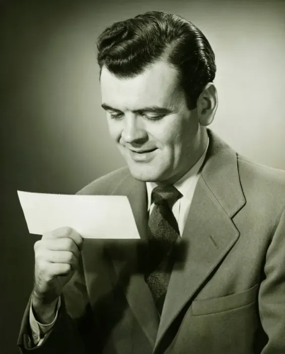 Framed Print : Smiling businessman looking at bank check, (B&W), portrait Framed Print : Smiling businessman looking at bank check, (B&W), portrait