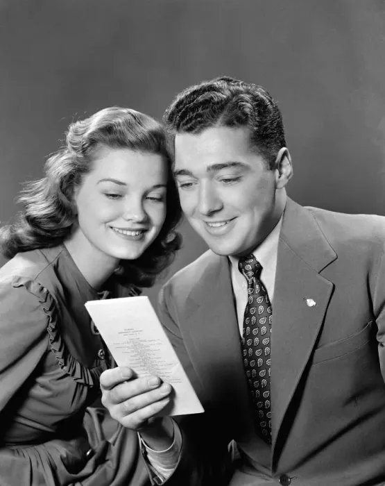 Framed Print : Smiling couple looking at insurance policy brochure Framed Print : Smiling couple looking at insurance policy brochure
