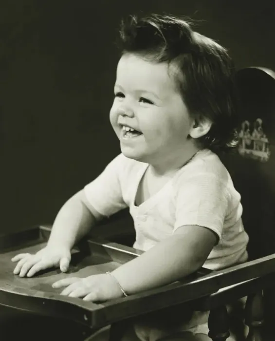 Framed Print : Smiling girl (2-3) sitting in high chair, (B&W) Framed Print : Smiling girl (2-3) sitting in high chair, (B&W)