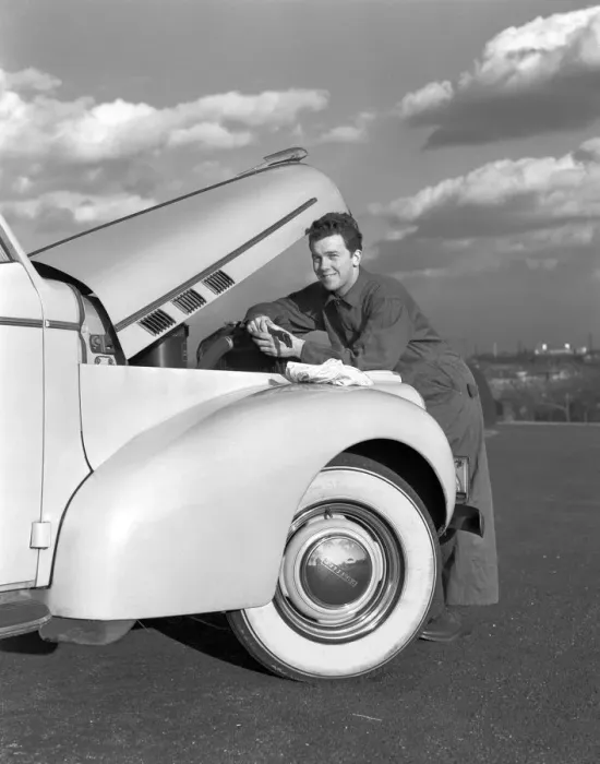 Framed Print : Smiling man in coveralls under hood of sedan, holding monkey wrench Framed Print : Smiling man in coveralls under hood of sedan, holding monkey wrench