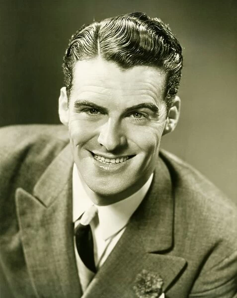 Smiling man posing in studio, (B&W), close-up, portrait
