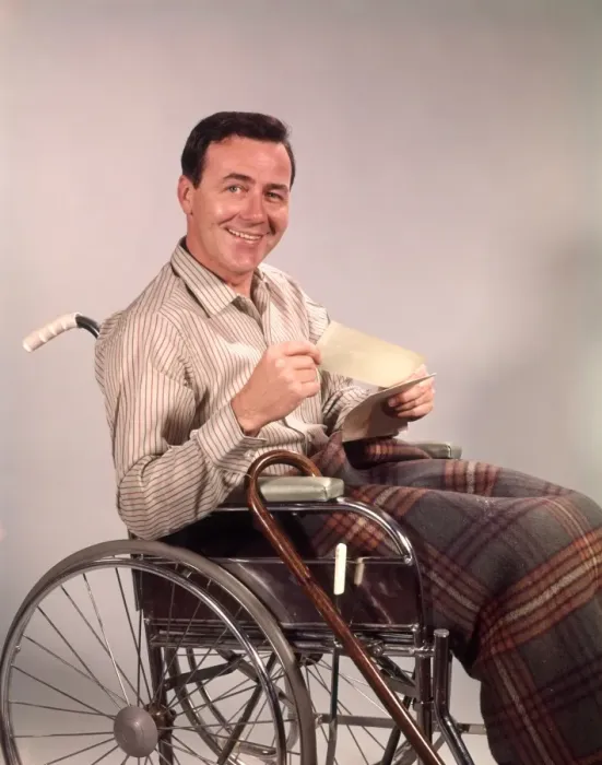 Framed Print : Smiling man in wheelchair, holding insurance check Framed Print : Smiling man in wheelchair, holding insurance check
