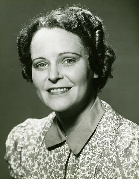 Smiling mature woman posing in studio, (B&W), portrait, close-up