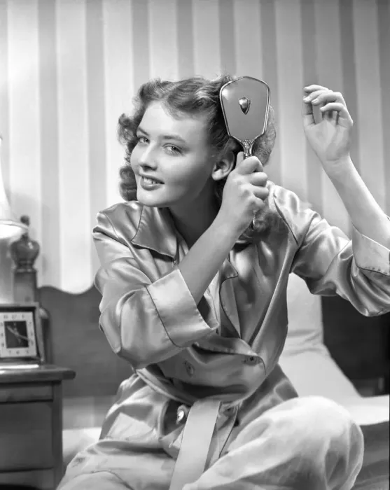 Framed Print : Smiling teenage girl in bathrobe brushing hair in the morning Framed Print : Smiling teenage girl in bathrobe brushing hair in the morning