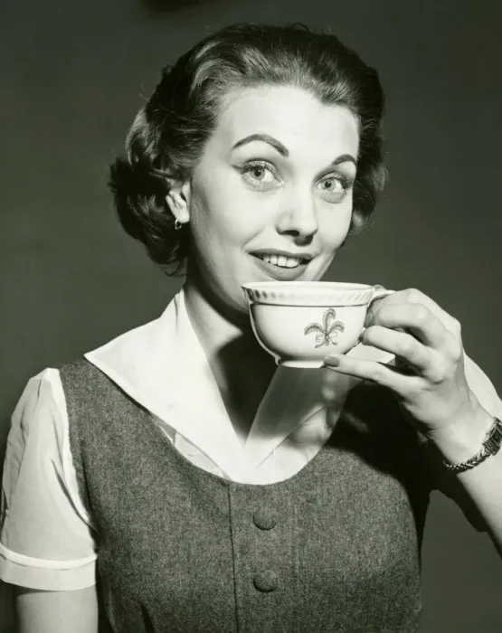 Framed Print : Smiling woman holding cup, posing in studio, (B&W), portrait Framed Print : Smiling woman holding cup, posing in studio, (B&W), portrait