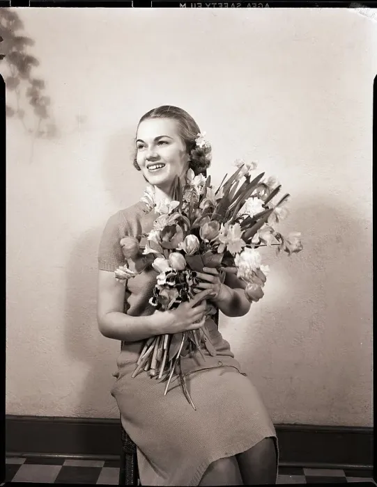 Framed Print : Smiling Woman Holding Flowers