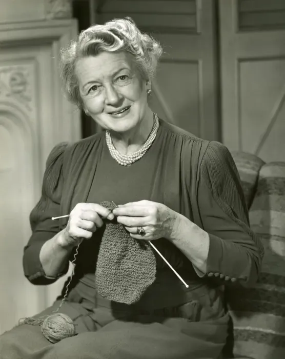 Framed Print : Smiling woman knitting Framed Print : Smiling woman knitting