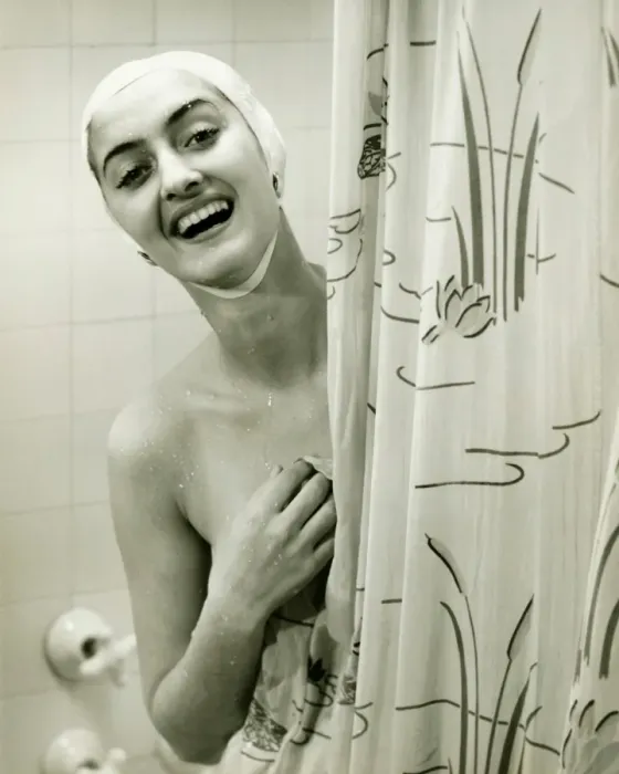 Framed Print : Smiling woman peeping behind shower curtain, (B&W), portrait Framed Print : Smiling woman peeping behind shower curtain, (B&W), portrait