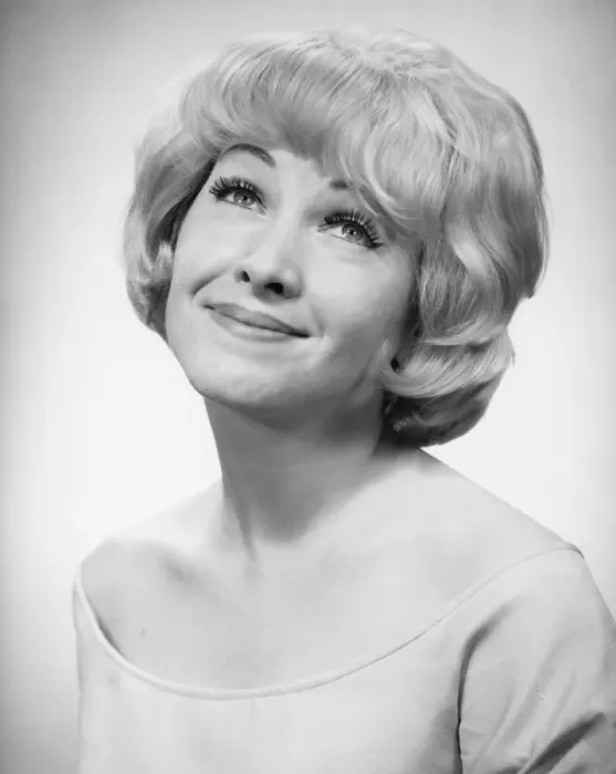 Framed Print : Smiling woman posing in studio, (B&W), portrait
