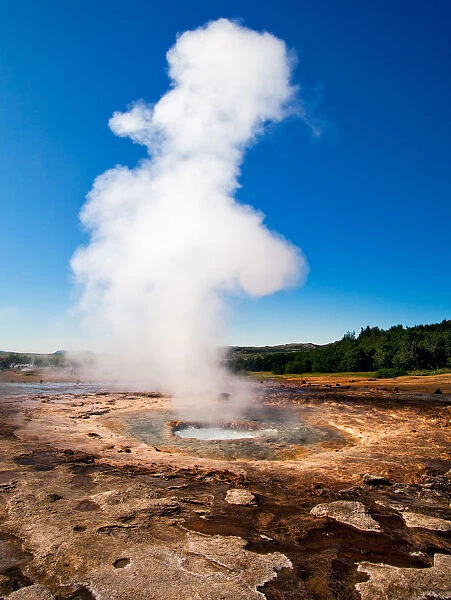 Smoking. Steam gives evidence of geothermal activity at Geysir - famous