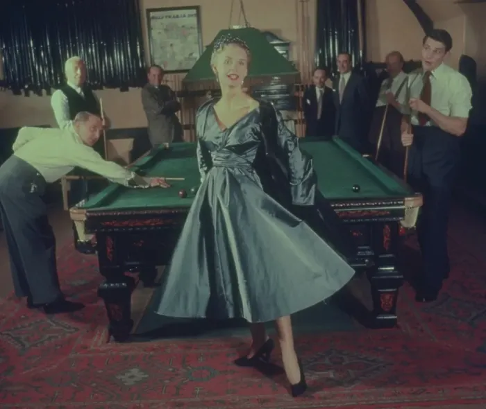 Framed Print : Snookered. A woman models a silver-blue dress and coat, in front of a snooker table Framed Print : Snookered. A woman models a silver-blue dress and coat, in front of a snooker table