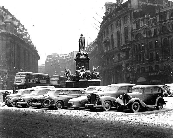 Snow covered cars in the Strand, London