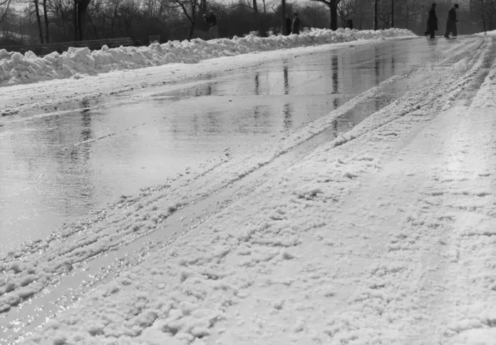 Framed Print : Snow-covered road in winter, with people in background