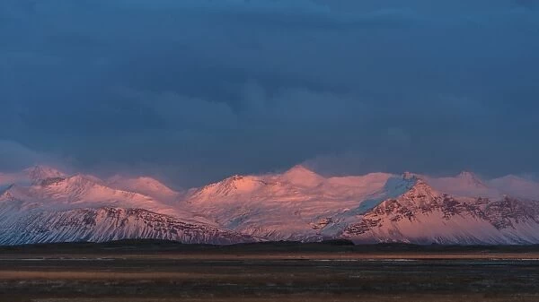 Snow mountain range in Iceland during sunset period