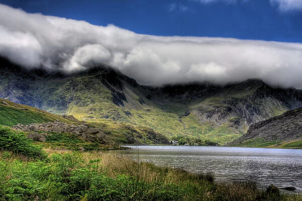 Snowdonia mountain range with cloud hanging suspended on hill tops during