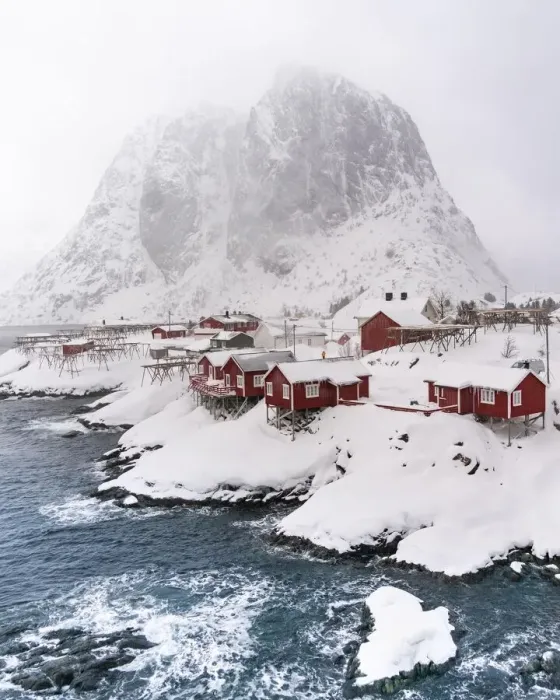 Framed Print : Snowstorm, red stilt houses, Hamnoy, drone shot, Lofoten, Norway