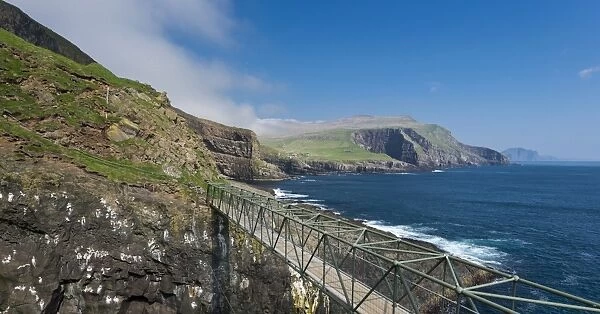 So-called Atlantic Bridge between Mykines and Mykinesholmur, rocky coast of Mykines, Vagar behind, Mykines, Utoyggjar, Faroe Islands, Denmark