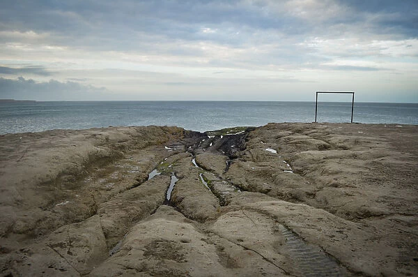 Soccer goal post by ocean shore Argentina
