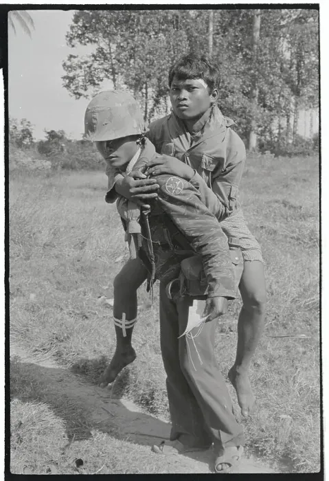 Framed Print : Soldier Carrying Injured Cambodian to Camp Framed Print : Soldier Carrying Injured Cambodian to Camp