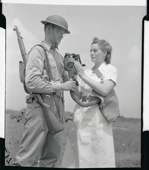 Framed Print : Soldier Explaining Gas Mask to Female Army Nurse Framed Print : Soldier Explaining Gas Mask to Female Army Nurse