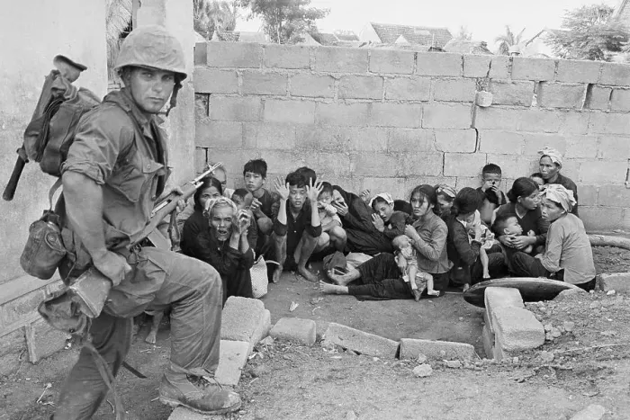 Framed Print : Soldier Guarding Civilians Framed Print : Soldier Guarding Civilians