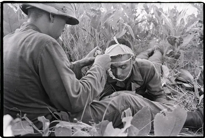 Framed Print : Soldier Helps Another Soldier with Bandage Framed Print : Soldier Helps Another Soldier with Bandage