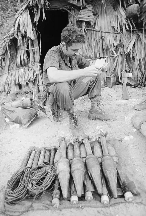 Framed Print : Soldier Seated Near Rockets Reading Framed Print : Soldier Seated Near Rockets Reading