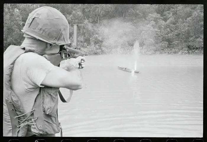 Framed Print : Soldier Shooting a Sampan Framed Print : Soldier Shooting a Sampan