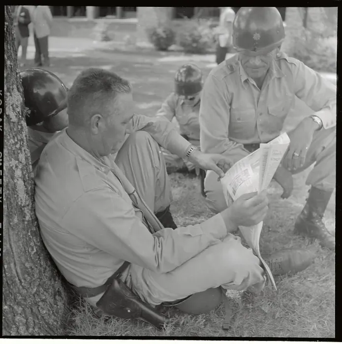 Framed Print : Soldier Sitting on Ground with Newspaper Framed Print : Soldier Sitting on Ground with Newspaper