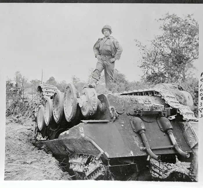 Framed Print : US Soldier Standing Atop Overturned Tank