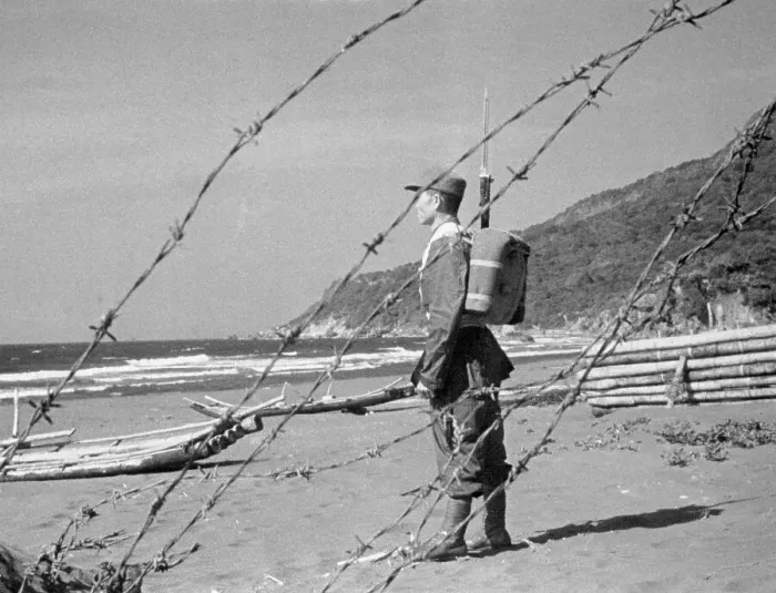 Framed Print : Soldier Standing Alone Near Fence Framed Print : Soldier Standing Alone Near Fence