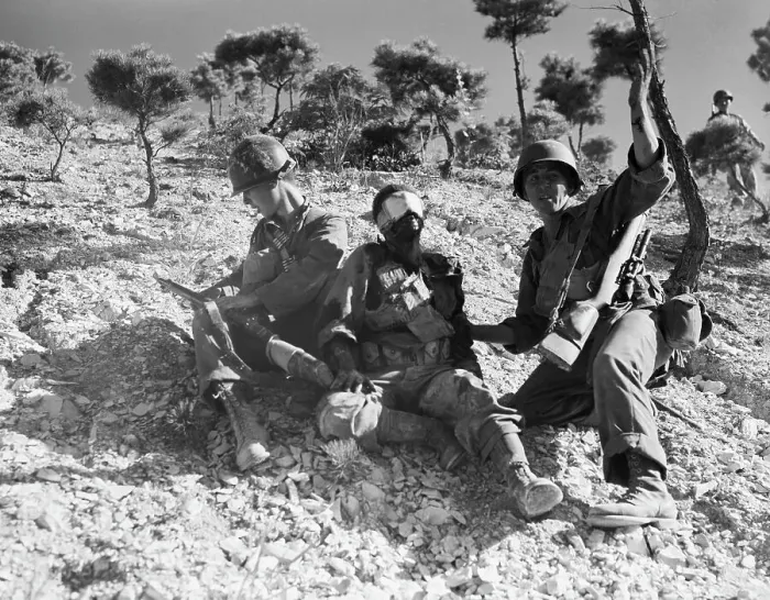 Framed Print : Soldier Waves For Help For Injured Chum