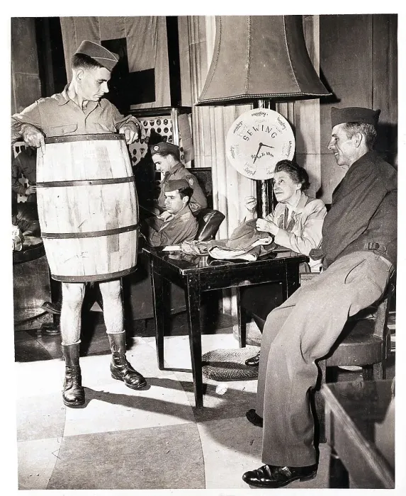 Framed Print : Soldier Wears Barrel while Woman Sews Pants