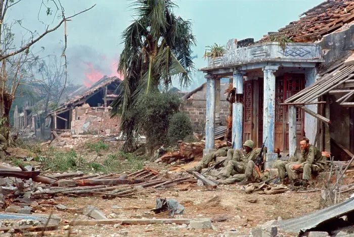 Framed Print : Soldiers Sitting in Front of a Damaged House