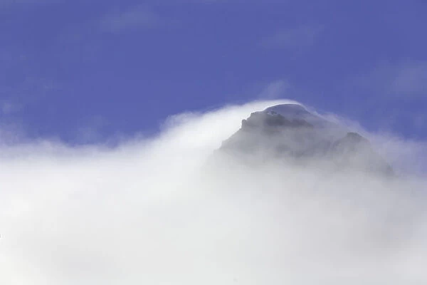 South Georgia, mountain peak enshrouded in fog, autumn morning