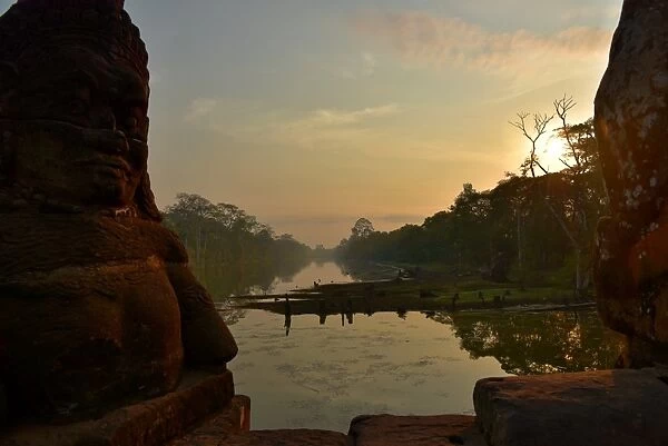 Southgate moat at sunrise with statues Angkor Siem Reap Cambodia