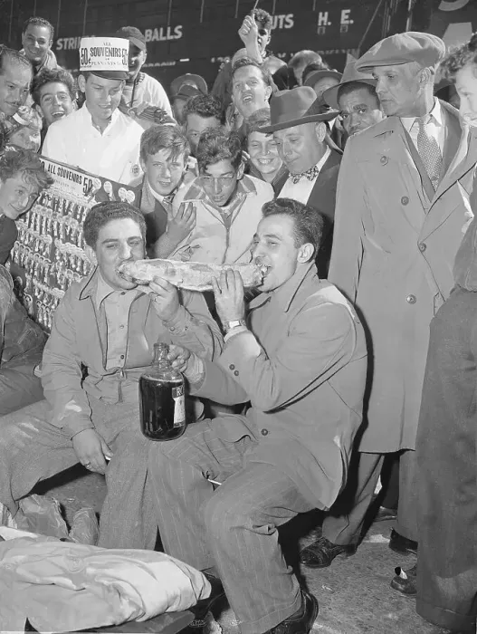 Framed Print : Spectators Watching Two Men Eating a Sandwich Framed Print : Spectators Watching Two Men Eating a Sandwich