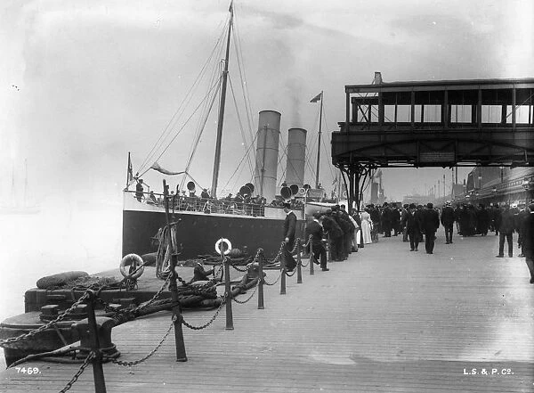 St Elvies. circa 1910: A ship arriving at the landing stage at Pier Head