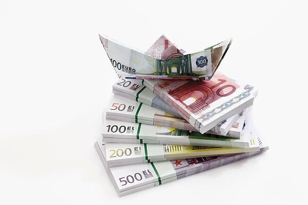 Stacked euro notes in bundles with boat made from notes