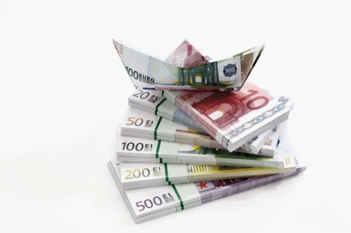 Framed Print : Stacked euro notes in bundles with boat made from notes Framed Print : Stacked euro notes in bundles with boat made from notes