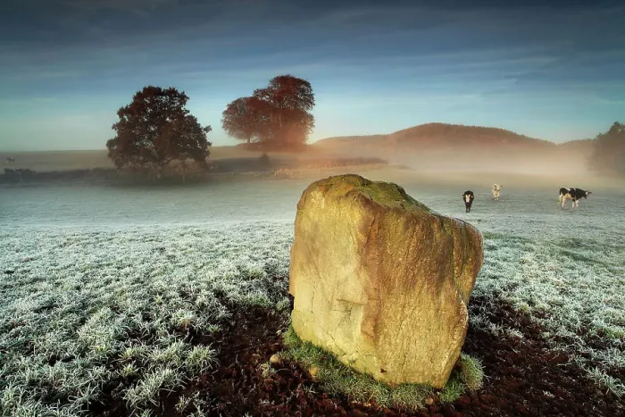 Framed Print : Standing stone on frosty field