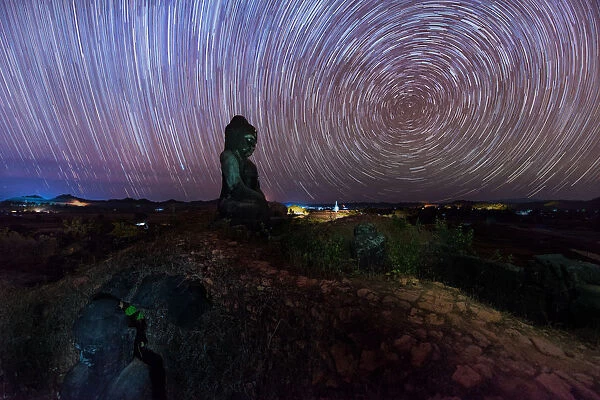 Startrails over old ruins of Buddha statues