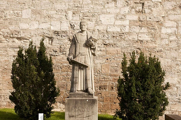 Statue of the preacher Thomas Muntzer in front of the city walls of Muhlhausen, Unstrut Hainich district, Thuringia, Germany