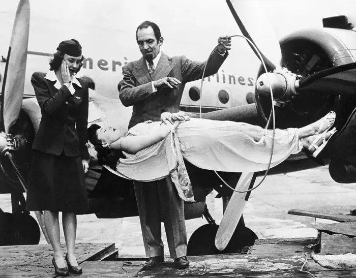 Framed Print : Stewardess Watching Magician Levitate Woman