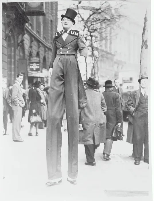 Framed Print : Stilt Walker Strolling with Pedestrians Framed Print : Stilt Walker Strolling with Pedestrians