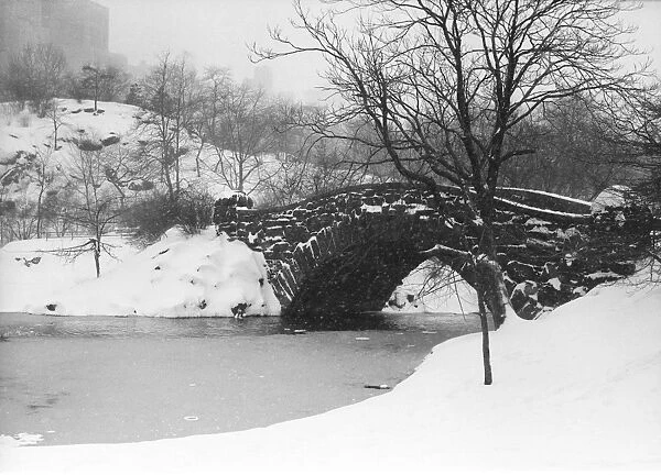 Stone bridge over snow-covered river