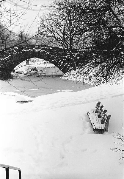 Stone bridge over snowcovered river