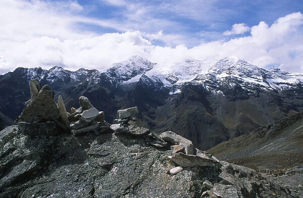 Stone Cairn with Snow-Capped Mountains in the Background