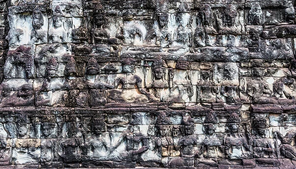 Stone Carving of Figures on a Wall In Angkor Wat